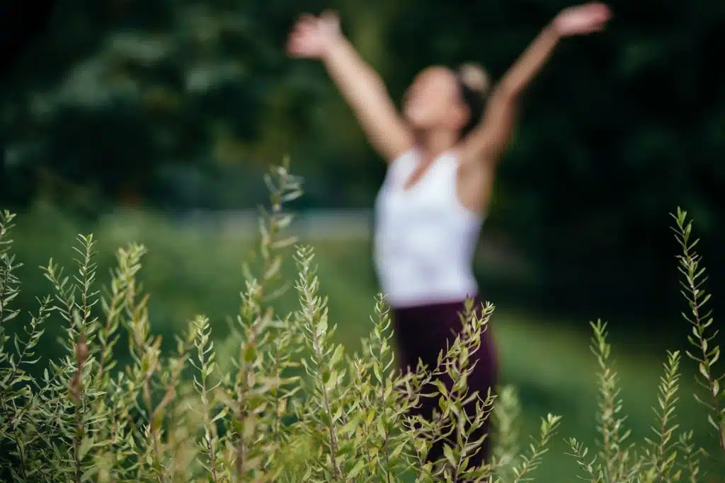 Frau übt Entspannung und Yoga im Garten
